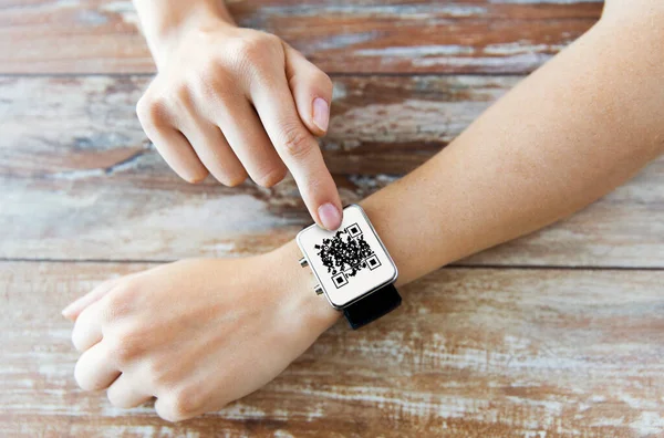 Womans hands with qr code on smart watch — Stock Photo, Image