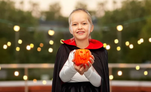 Girl in halloween costume of dracula with pumpkin — Stock Photo, Image