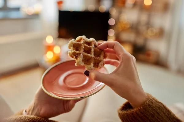 Manos de mujer joven comiendo waffle en casa — Foto de Stock