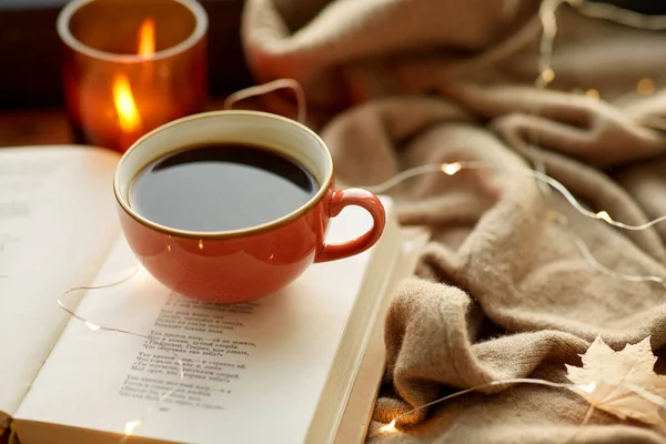 Cup of coffee, book on window sill in autumn — Stock Photo, Image