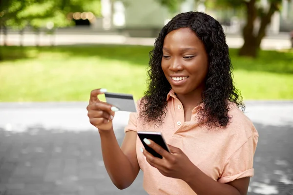 スマートフォンやクレジットカードを持つアフリカの女性は — ストック写真