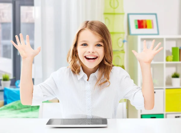 Happy laughing student girl with tablet pc at home — Stock Photo, Image