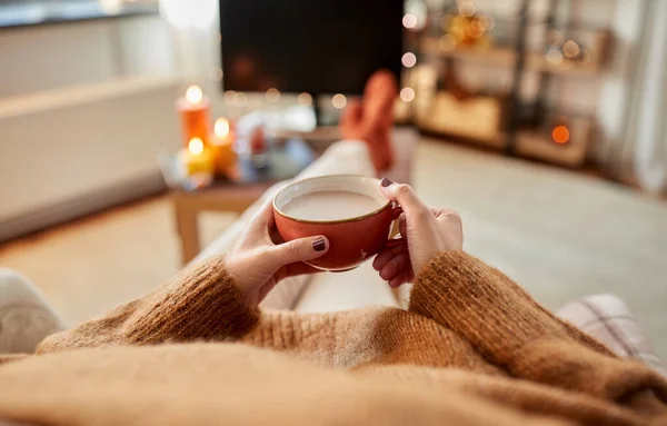 Manos de mujer bebiendo chocolate caliente en casa — Foto de Stock