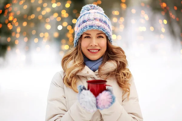 Happy young woman with tea cup outdoors in winter — Stock Photo, Image