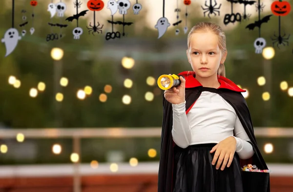 Girl in halloween costume of dracula with candies — Stock Photo, Image