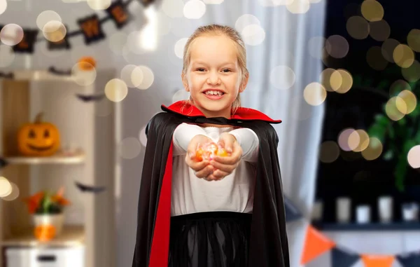 Girl in halloween costume of dracula with candies — Stock Photo, Image