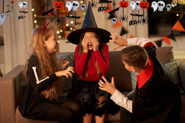 Ungar i halloween kostymer leker hemma — Stockfoto