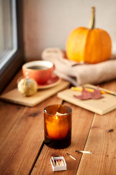 Candle and matches on window sill in autumn — Stock Photo, Image