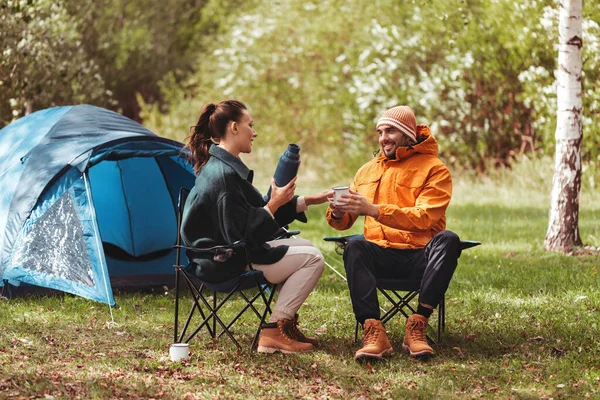 Šťastný pár pije čaj na táboře stan — Stock fotografie