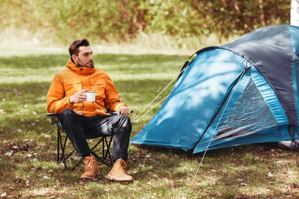 Homem feliz bebendo chá no acampamento da barraca — Fotografia de Stock