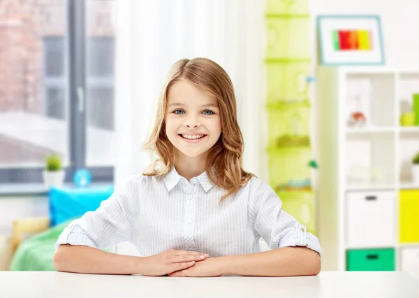 Happy smiling student girl sitting at table — Stock Photo, Image