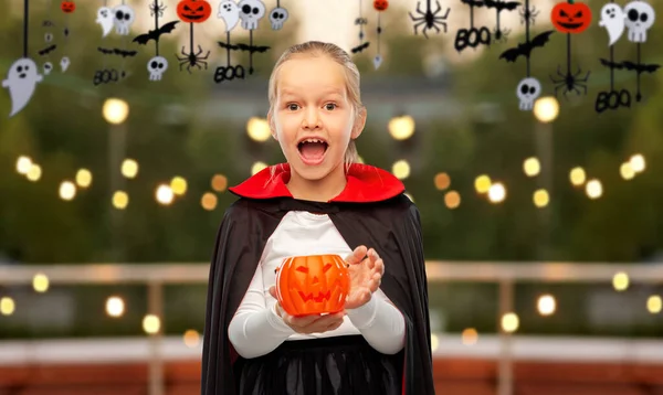 Girl in halloween costume of dracula with pumpkin — Stock Photo, Image