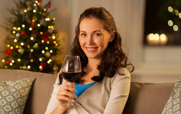 Woman drinking red wine at home on christmas — Stock Photo, Image