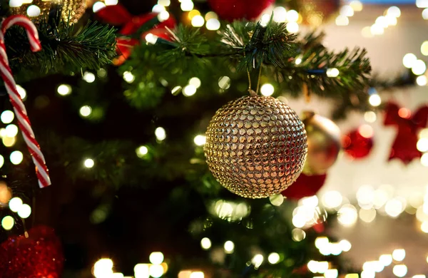 Golden christmas ball decoration on fir tree — Stock Photo, Image