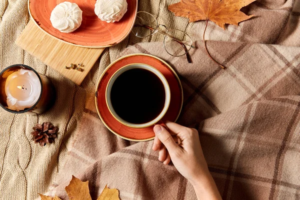 Šálek kávy, podzimní listí a svíčka v posteli — Stock fotografie