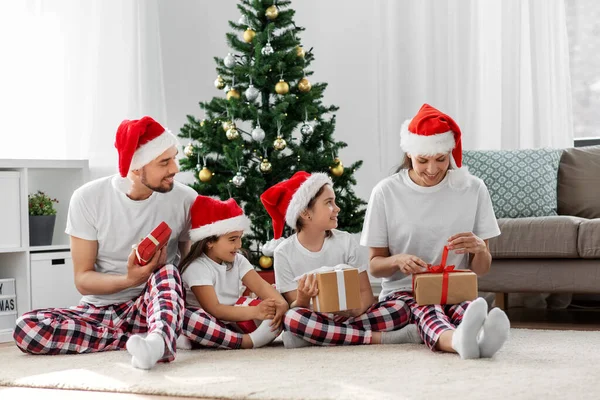 Happy family opening christmas gifts at home — Stock Photo, Image