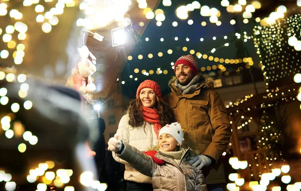 Щаслива сім'я на різдвяному ринку в місті — стокове фото