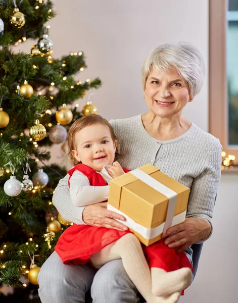 Avó e bebê menina com presente de Natal — Fotografia de Stock