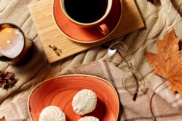 Xícara de café, folhas de outono e vela na cama — Fotografia de Stock