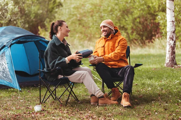 Happy couple drinking tea at tent camp — Stock Photo, Image