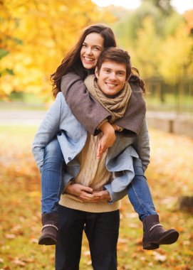 smiling couple hugging in autumn park clipart