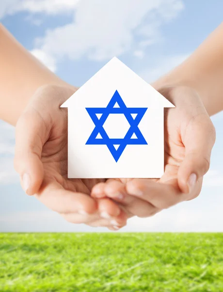 Close up of hands holding house with star of david — Stock Photo, Image