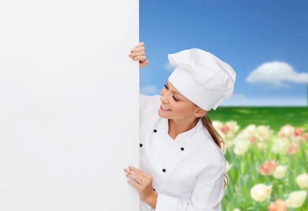 Smiling female chef with white blank board — Stock Photo, Image