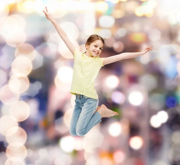 Smiling little girl jumping — Stock Photo, Image