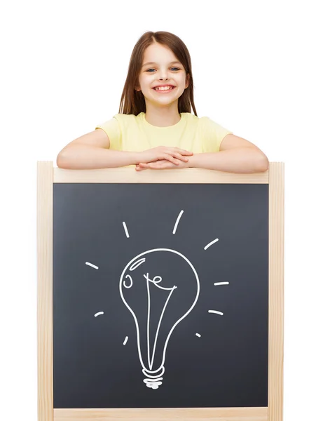 Happy little girl with blackboard — Stock Photo, Image