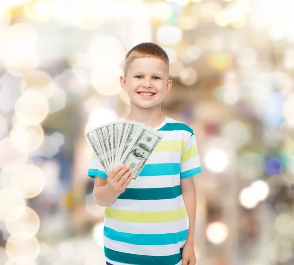 Sorrindo menino segurando dinheiro em dinheiro dólar em sua mão — Fotografia de Stock