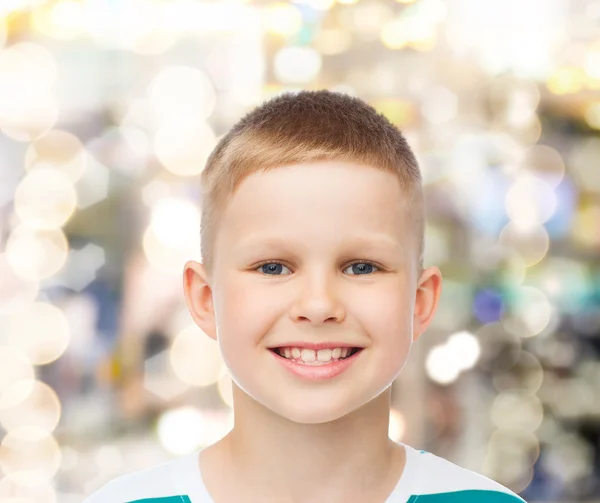 Smiling little boy over sparkling background — Stock Photo, Image