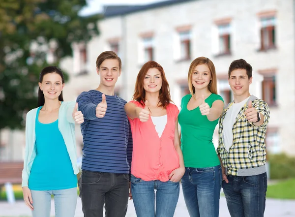 Gruppe lächelnder Studenten zeigt Daumen hoch — Stockfoto