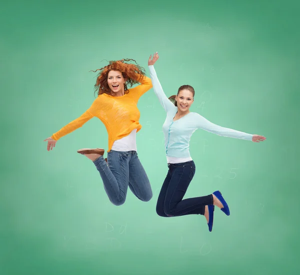 Smiling young women jumping in air — Stock Photo, Image