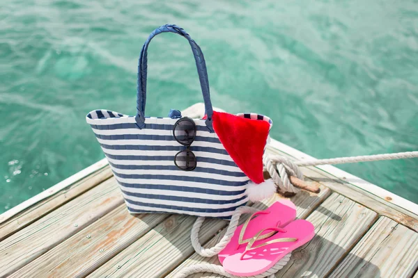 Close up of beach accessories and santa helper hat — Stock Photo, Image