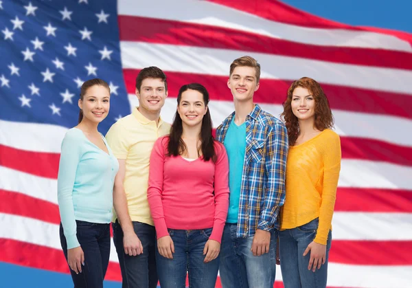 Group of smiling teenagers over american flag Stock Picture
