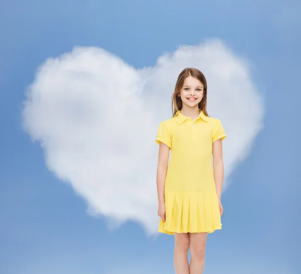 Smiling little girl in yellow dress — Stock Photo, Image