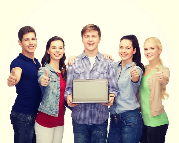 Smiling students with laptop computer — Stock Photo, Image