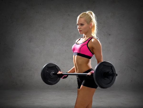 Sporty woman exercising with barbell — Stock Photo, Image