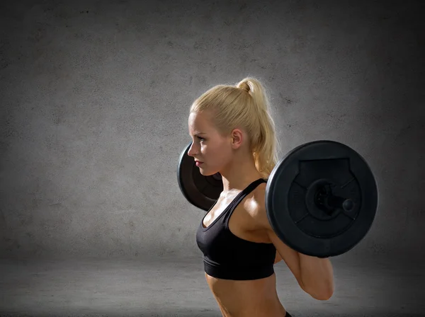 Sporty woman exercising with barbell — Stock Photo, Image