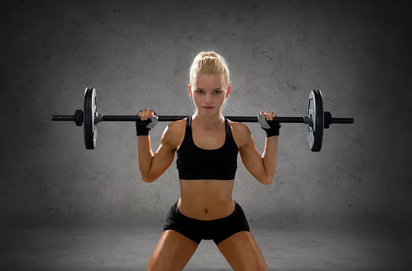 Sporty woman exercising with barbell — Stock Photo, Image