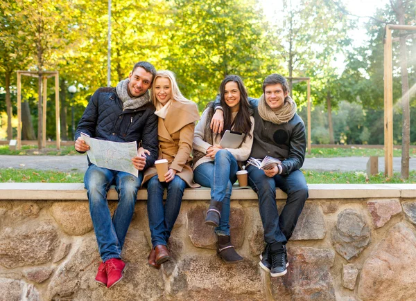 Group of friends with map outdoors — Stock Photo, Image