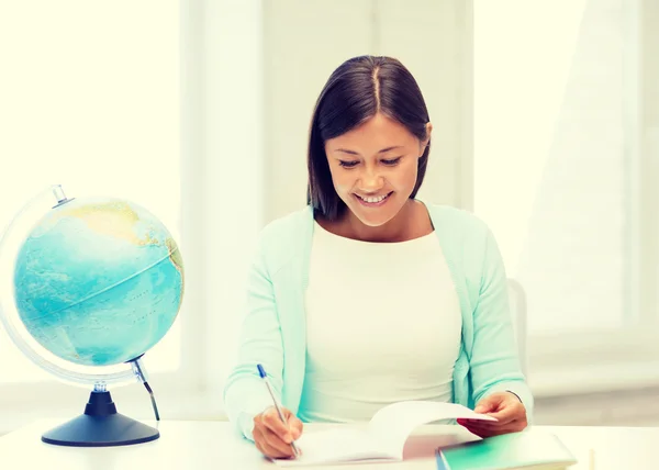 Enseignant avec globe et bloc-notes à l'école — Photo