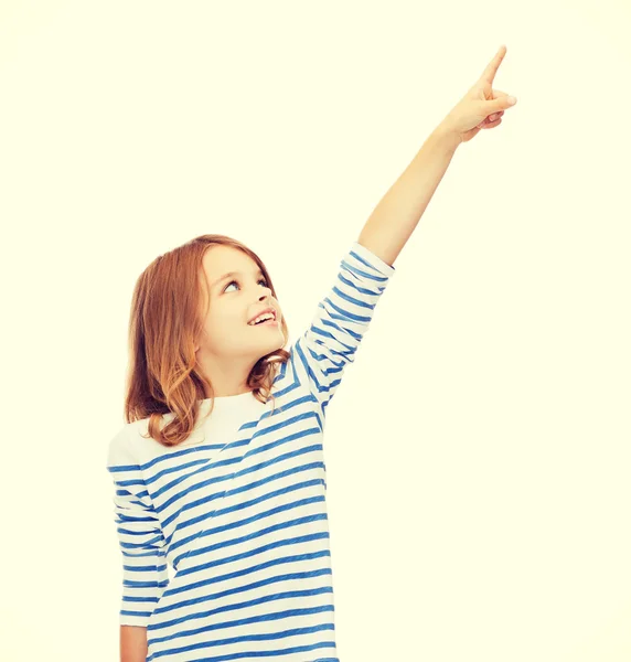 Smiling girl pointing at virtual screen — Stock Photo, Image