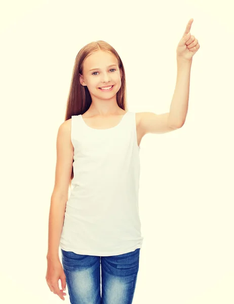 Girl in blank white shirt pointing to something — Stock Photo, Image