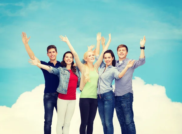 Group of smiling students waving hands — Stock Photo, Image