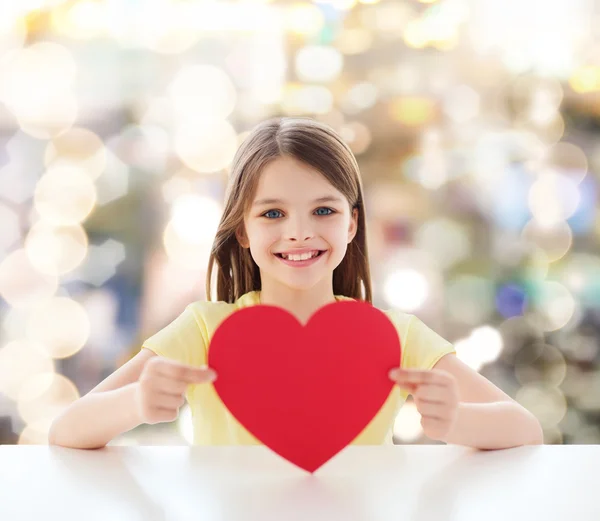 Beautiful little girl sitting at table — Stock Photo, Image