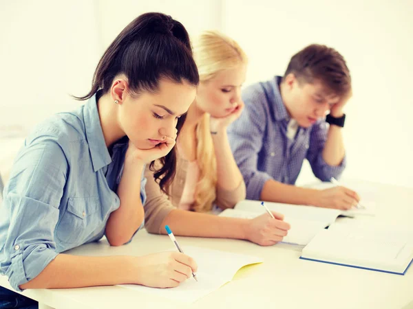 Tired students with notebooks at school — Stock Photo, Image