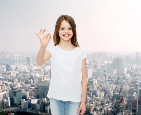 Smiling little girl in white blank t-shirt — Stock Photo, Image