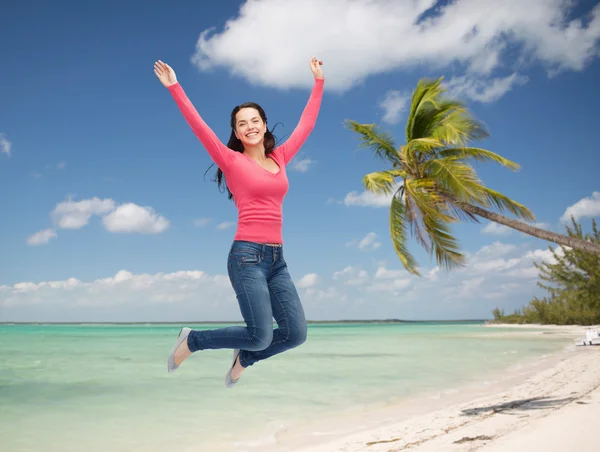 Smiling young woman jumping in air — Stock Photo, Image