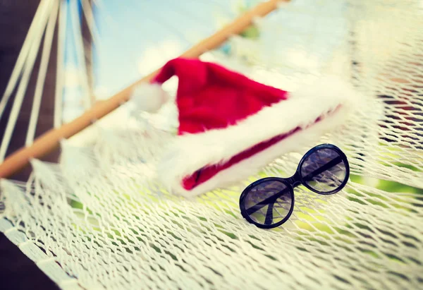 Hammock with santa helper hat and shades — Stock Photo, Image